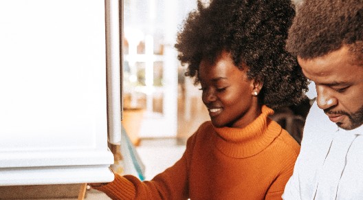 photo of a couple cooking together