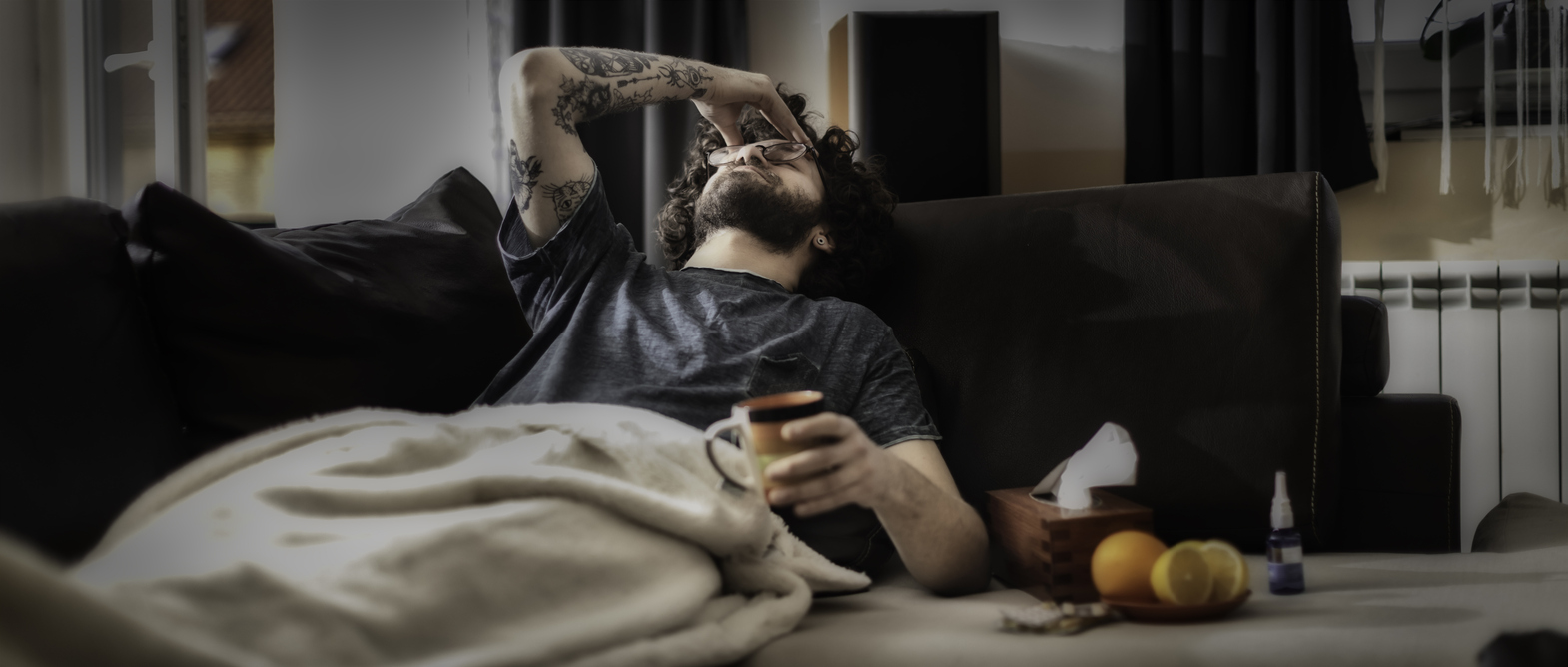 Young man suffering from headache, migraine or hangover at home.