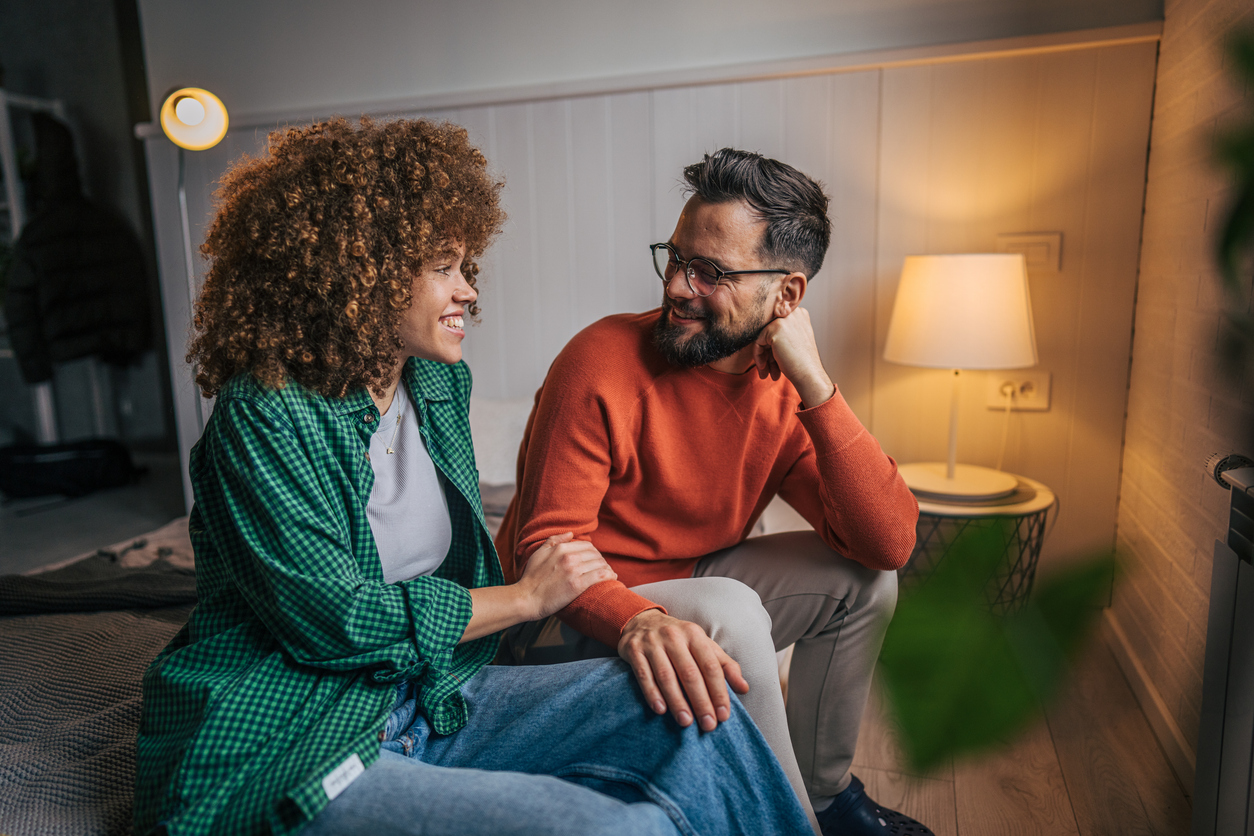 Couple relaxing in bedroom at home